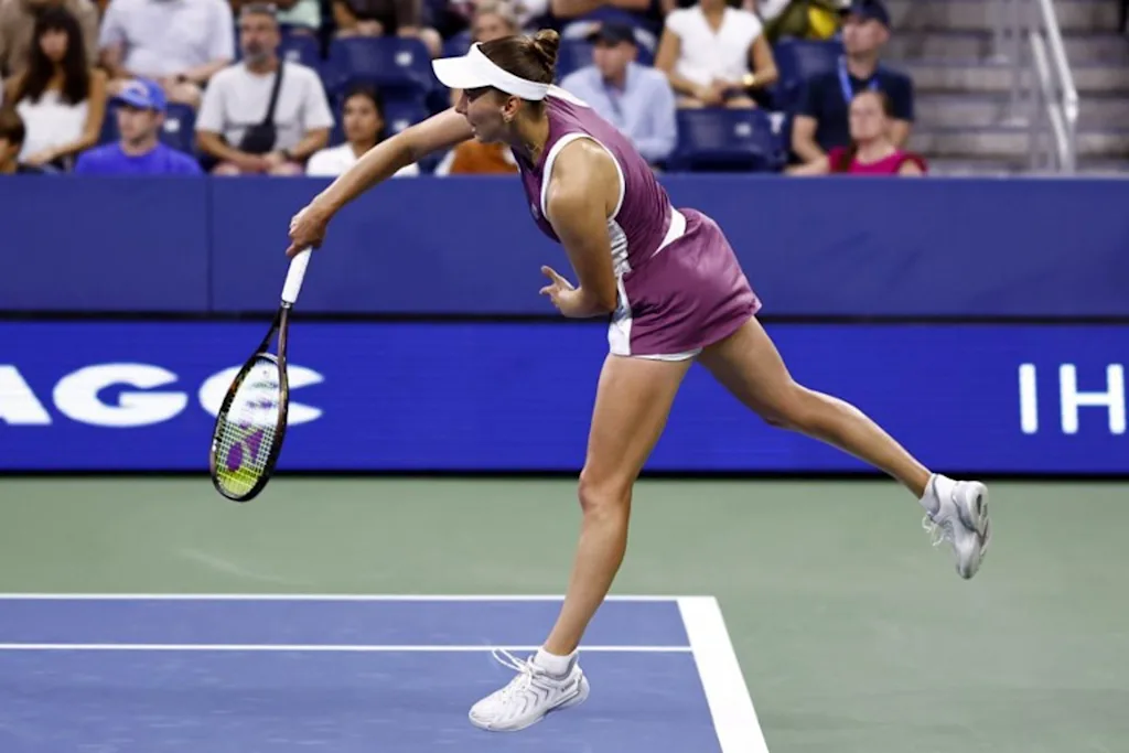 Belgium's Elise Mertens serves to Japan's Naomi Osaka in their women's singles third round tennis match on day seven of the US Open tennis tournament at the USTA Billie Jean King National Tennis Center in New York City on September 5, 2026. kena betancur / AFP