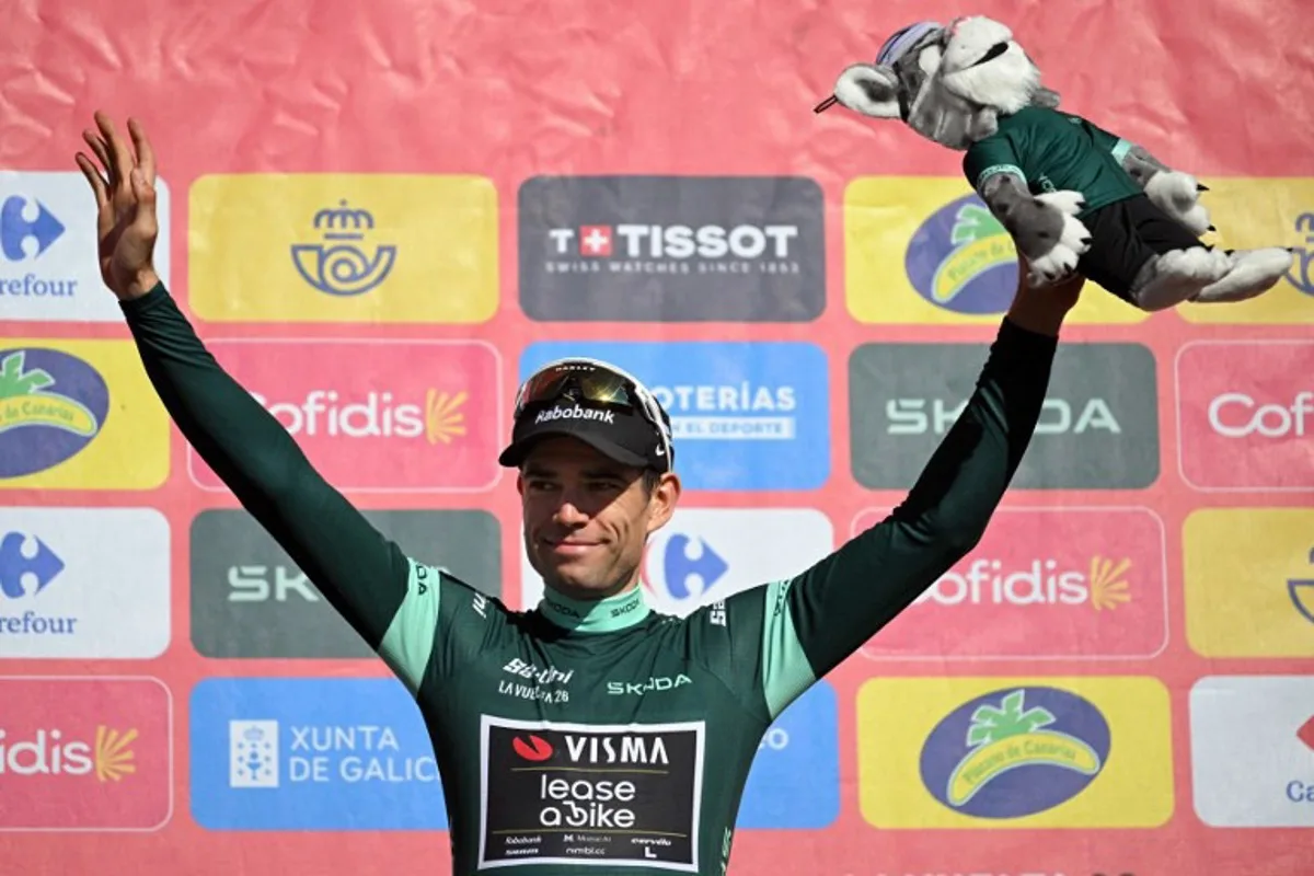 Team Visma-Lease a bike's Belgian rider Wout van Aert celebrates on the podium retaining the points leader's green jersey after the 20th stage of the Vuelta a Espana 2026 cycling tour, a 186,8 km race between La Calahorra and Collado del Alguacil, on September 12, 2026.   JORGE GUERRERO / AFP
