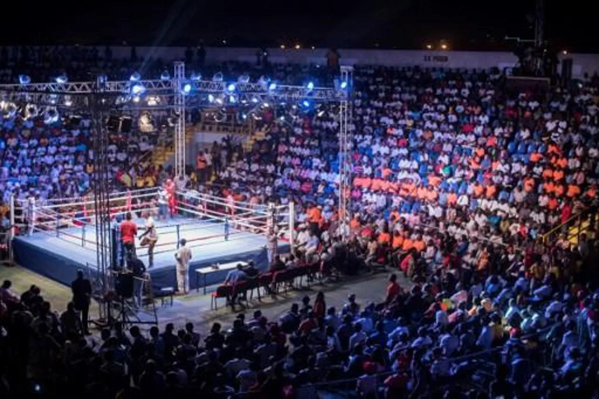 Fans attend the opening of the Bukom Boxing Arena, one of the buildings inside the Trust Sports Emporium complex with a capacity for more than 4000 people, in Accra, November 15, 2016. 
CRISTINA ALDEHUELA / AFP