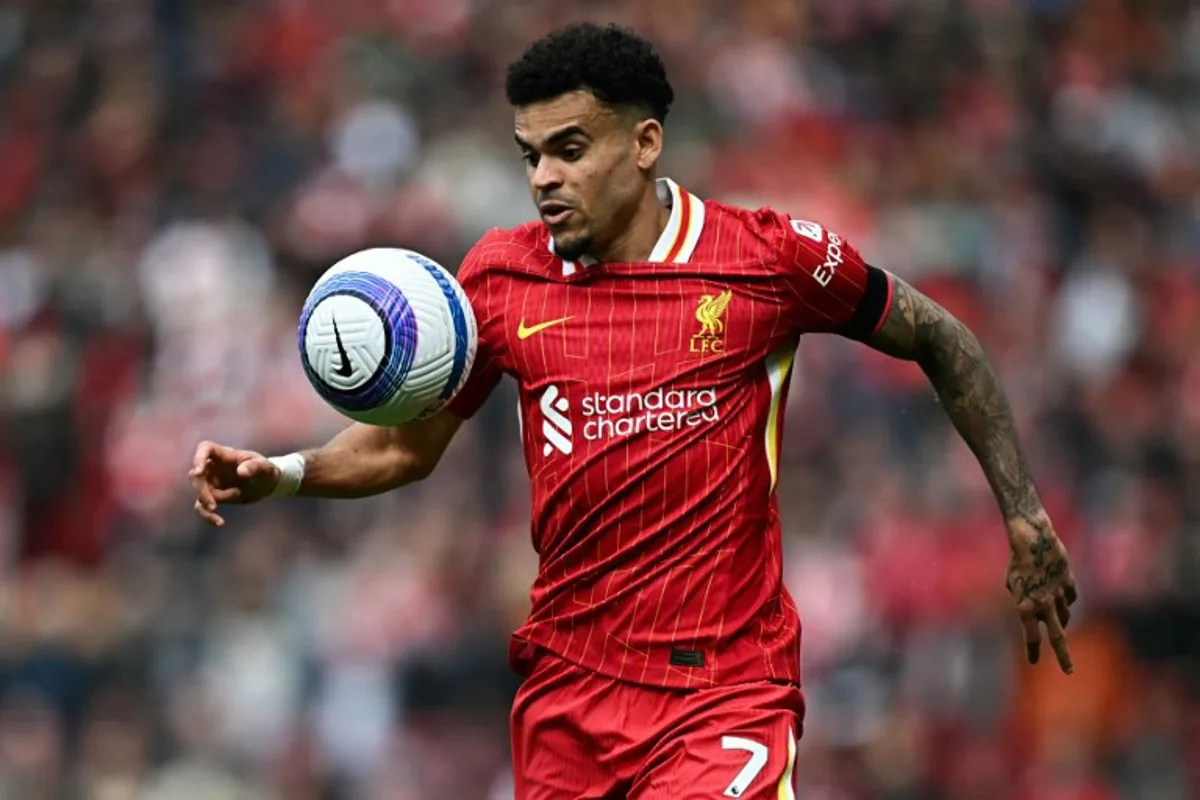 Liverpool's Colombian midfielder #07 Luis Diaz eyes the ball during the English Premier League football match between Liverpool and West Ham United at Anfield in Liverpool, north west England on April 13, 2025. Paul ELLIS / AFP