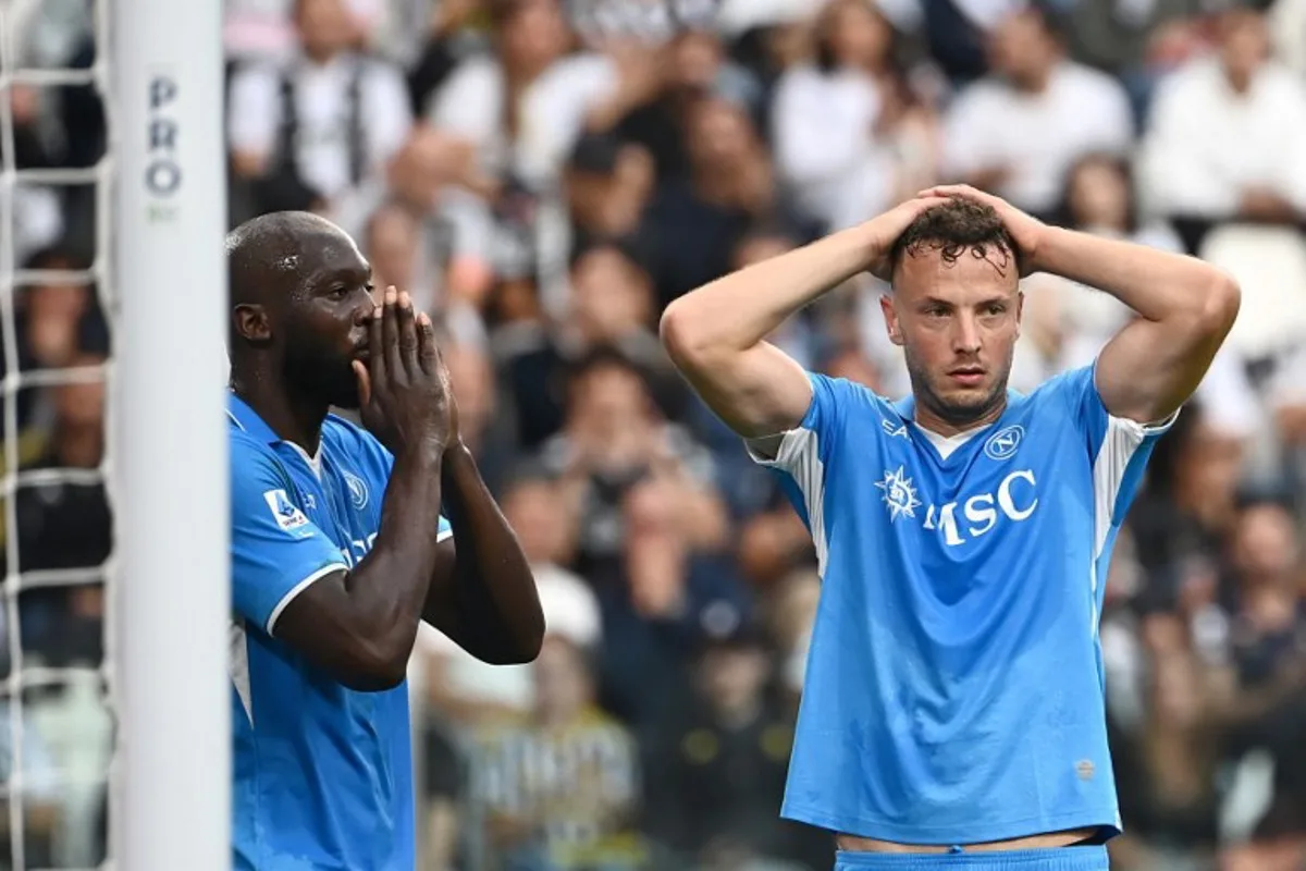 Napoli's Belgian forward #11 Romelu Lukaku (L) and Napoli's Kosovan defender #13 Amir Rrahmani react after a missing a goal opportunity during the Italian Serie A football match between Juventus and Napoli on September 21, 2024 at the Juventus stadium in Turin.  Isabella BONOTTO / AFP