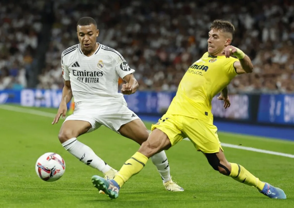 Real Madrid's French forward #09 Kylian Mbappe fights for the ball with Villarreal's Spanish defender #17 Kiko Femenia during the Spanish league football match between Real Madrid CF and Villarreal CF at the Santiago Bernabeu stadium in Madrid on October 5, 2024.  OSCAR DEL POZO / AFP