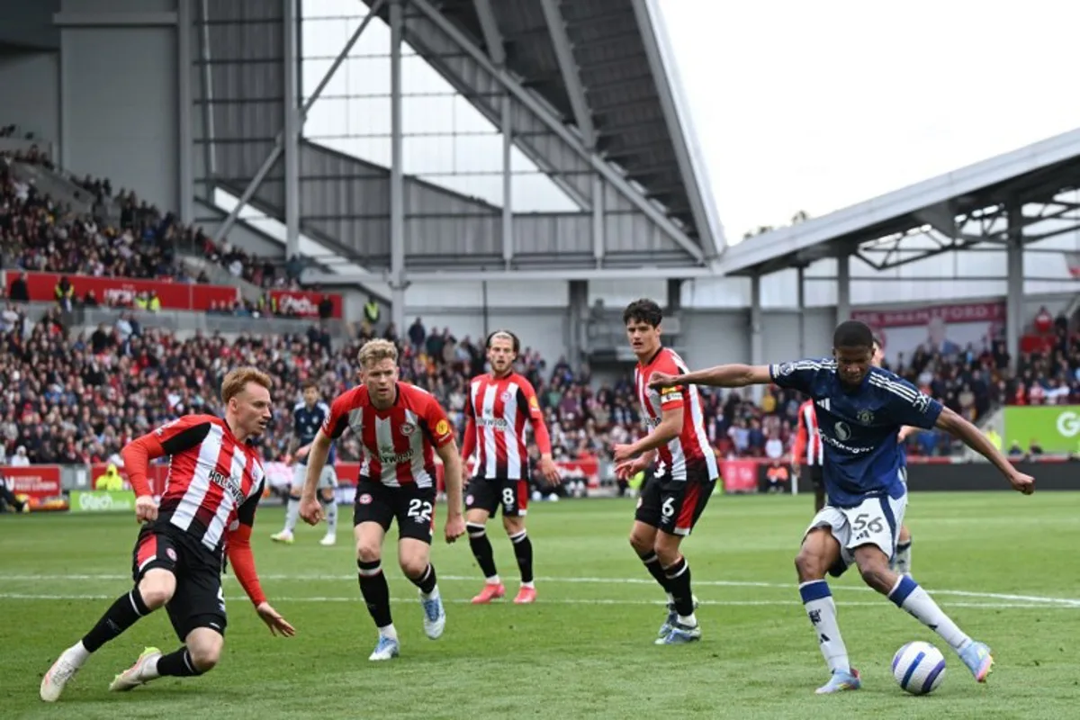 Manchester United's Norwegian striker #56 Chido Obi (R) shoots but fails to score during the English Premier League football match between Brentford and Manchester United at the Gtech Community Stadium in London on May 4, 2025. JUSTIN TALLIS / AFP