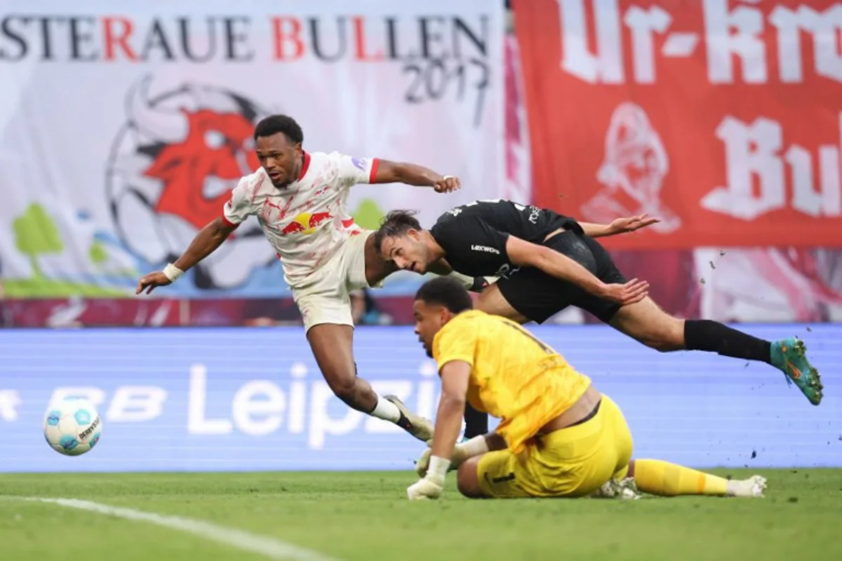 Leipzig's Belgian forward #11 Lois Openda scores his team's third goal 3:1 during the German first division Bundesliga football match between RB Leipzig and SC Freiburg in Leipzig, eastern Germany, on October 26, 2024.  Ronny HARTMANN / AFP