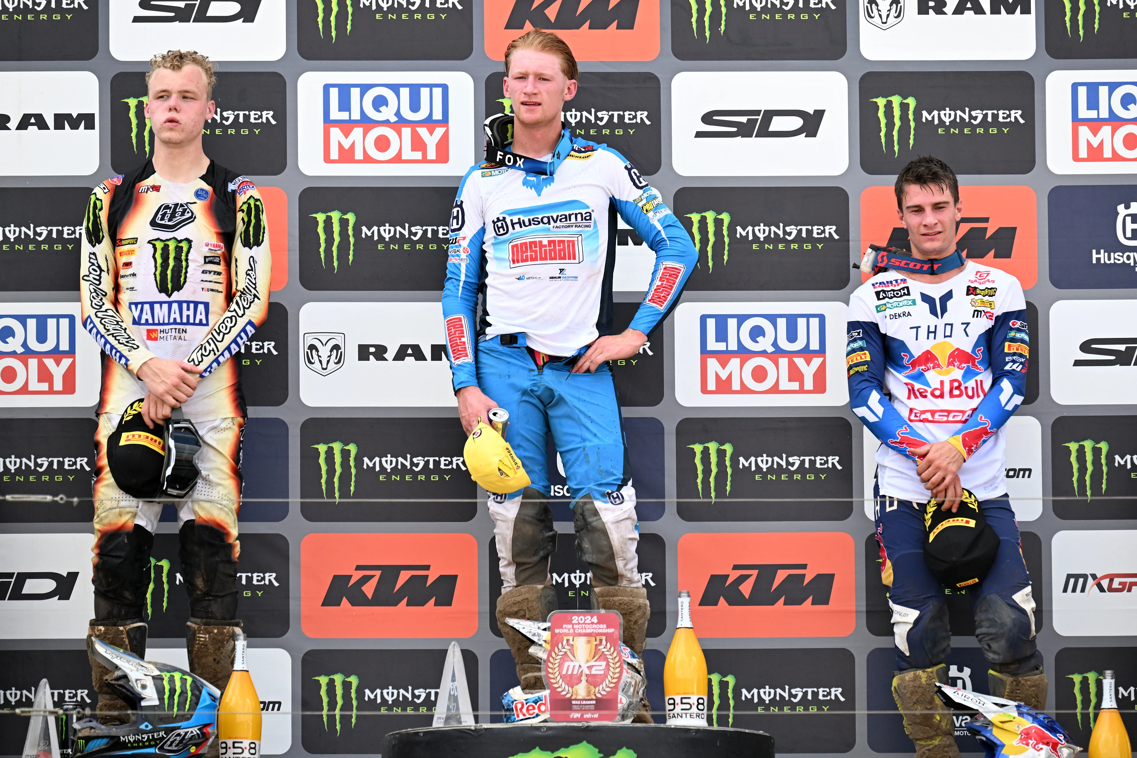 Dutch Rick Elzinga, Dutch Kay De Wolf and German Simon Langenfelder celebrate on the podium after the MX2 race at the motocross MXGP Grand Prix Flanders event, race 14/20 of the FIM Motocross World Championship, Sunday 28 July 2024 in Lommel. BELGA PHOTO MAARTEN STRAETEMANS