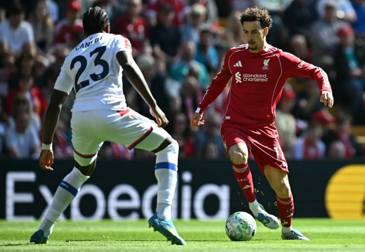 Crystal Palace's French defender #23 Jaydee Canvot (L) defends from Liverpool's English midfielder #17 Curtis Jones during the English Premier League football match between Liverpool and Crystal Palace at Anfield in Liverpool, north west England on April 25, 2026. Paul ELLIS / AFP