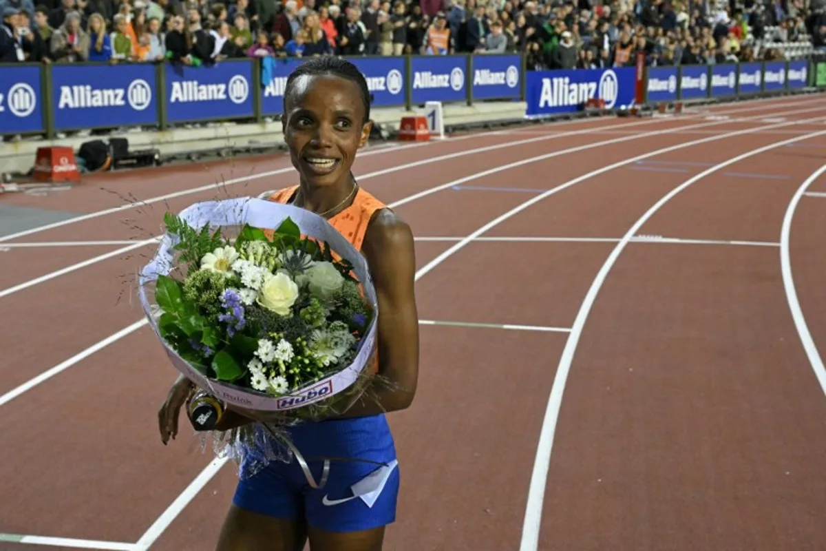 Kenya's Beatrice Chebet celebrates after winning the Women's 5000m final of the Memorial Van Damme Diamond League athletics finals and breaking the "Meeting Record" at the Roi Baudouin Stadium in Brussels on September 14, 2024.  NICOLAS TUCAT / AFP