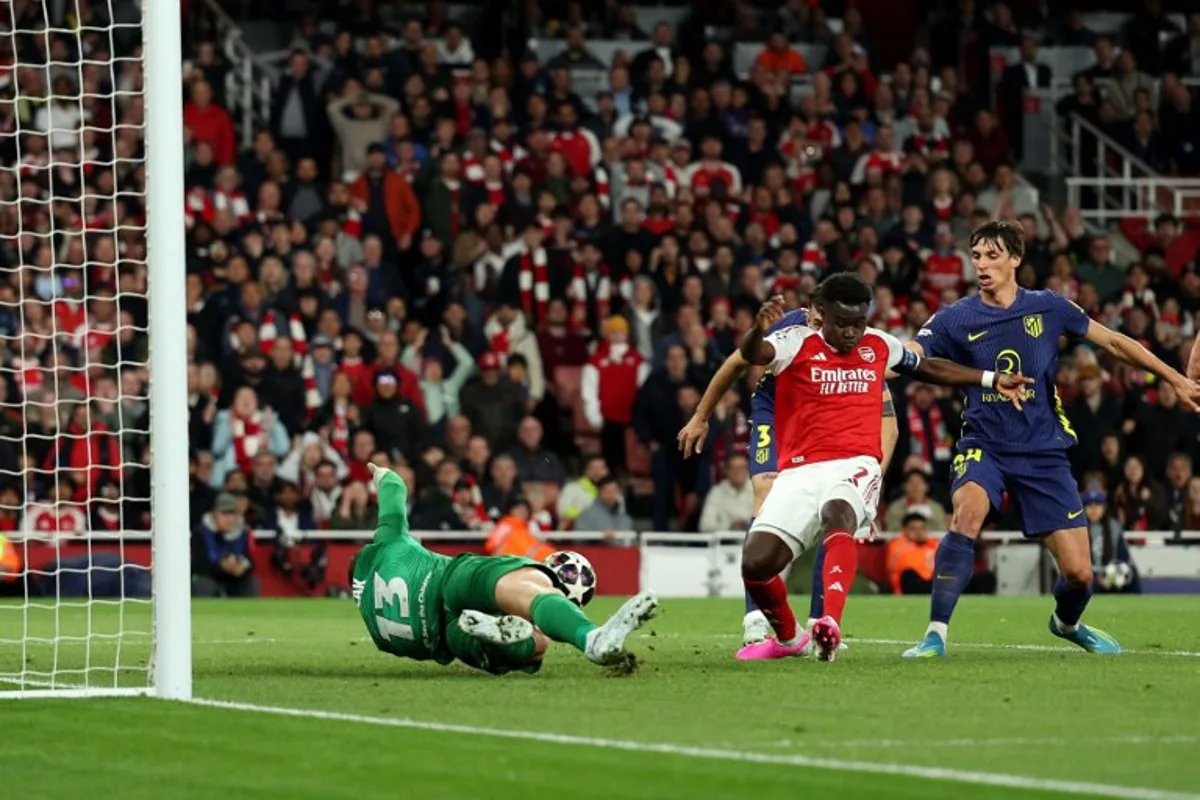 Arsenal's English midfielder #07 Bukayo Saka scores the team's first goal during the UEFA Champions League second-leg semi-final football match between Arsenal and Atletico Madrid at the Emirates Stadium in north London on May 5, 2026.  Adrian Dennis / AFP
