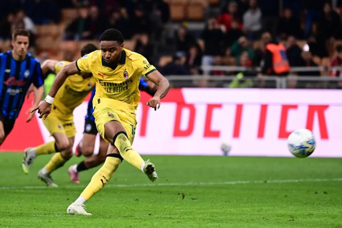 AC Milan's French forward #18 Christopher Nkunku scores a penalty kick during the Italian Serie A football match between AC Milan and Atalanta Bergamo at San Siro Stadium in Milan on May 10, 2026.  Piero CRUCIATTI / AFP