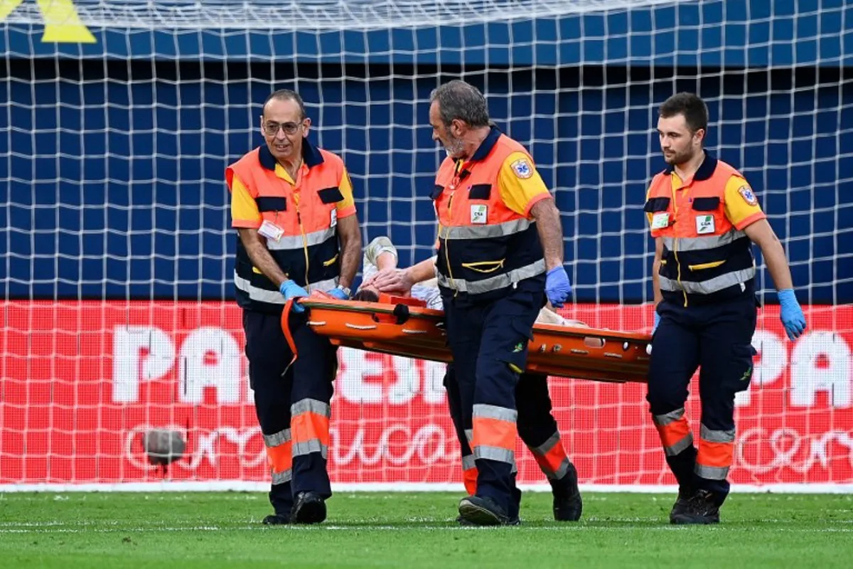 Barcelona's German goalkeeper #01 Marc-Andre Ter Stegen is escorted off-pitch on a stretcher during the Spanish league football match between Villarreal CF and FC Barcelona at La Ceramica stadium in Vila-real, on September 22, 2024.  JOSE JORDAN / AFP