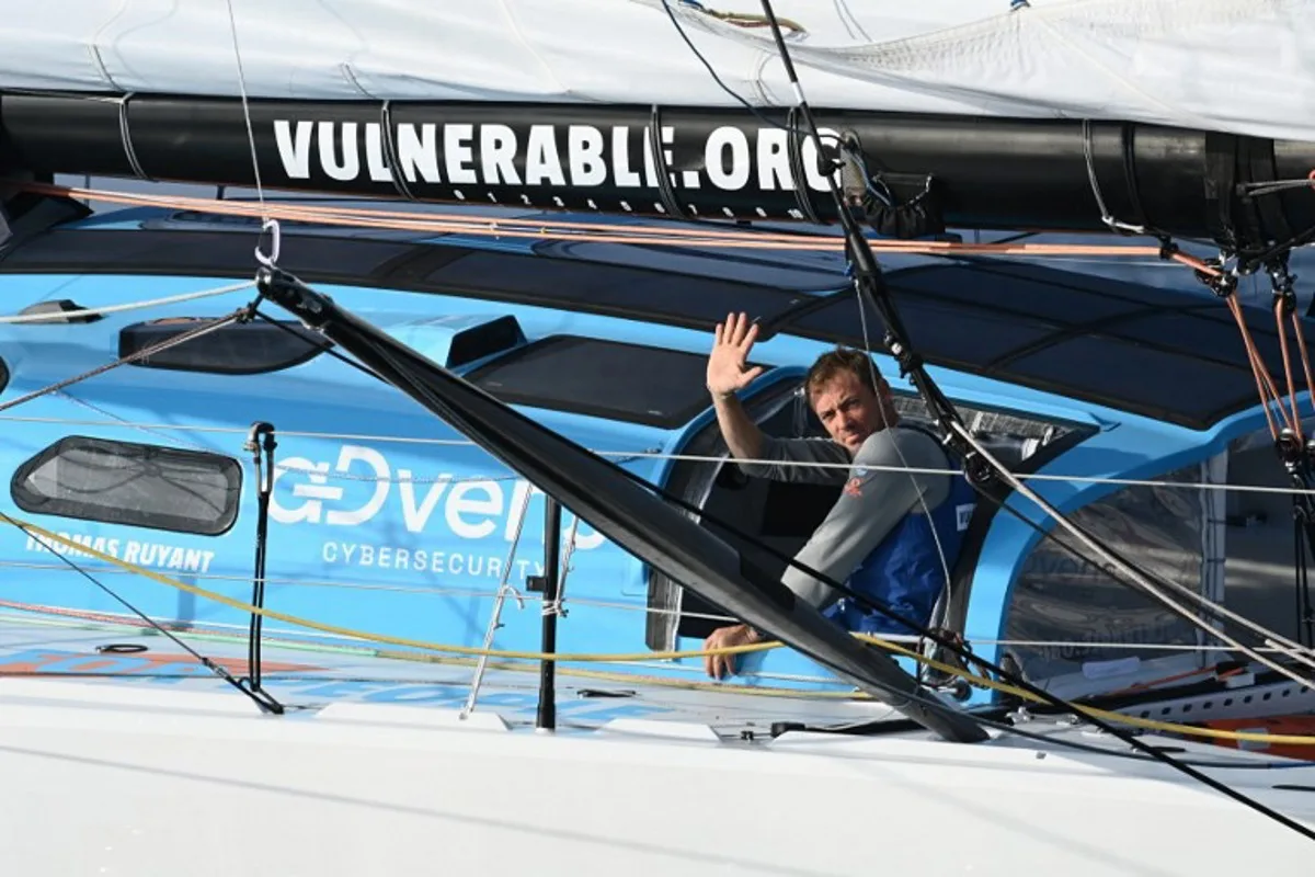 French skipper Thomas Ruyant waves as he sails his Imoca 60 "Vulnerable" after the start of the 10th edition of the Vendee Globe around the world monohull solo sailing race, off the coast of Les Sables-d'Olonne, western France, on November 10, 2024.  Christophe ARCHAMBAULT / AFP