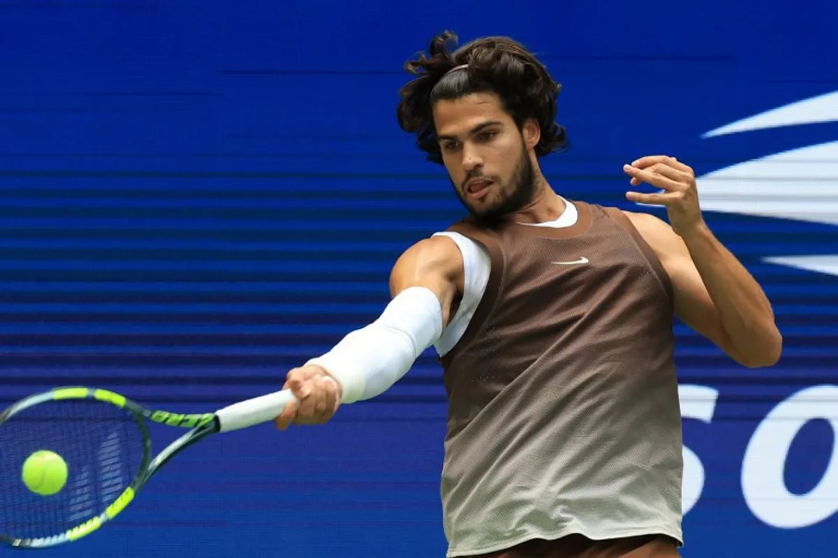 Spain's Carlos Alcaraz hits a return to China's Wu Yibing during their men's singles third round tennis match on day six of the US Open tennis tournament at the USTA Billie Jean King National Tennis Center in New York City on September 4, 2026. TIMOTHY A. CLARY / AFP