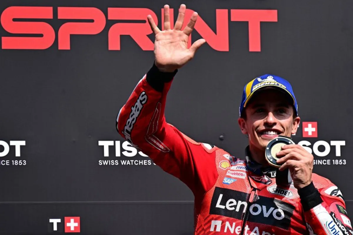 Ducati Lenovoi Team's Spanish MotoGP rider Marc Marquez celebrates after winning the sprint, on the eve of the Italian Moto GP Grand Prix at Mugello circuit, in Mugello, near Florence, on June 21, 2025. Tiziana FABI / AFP