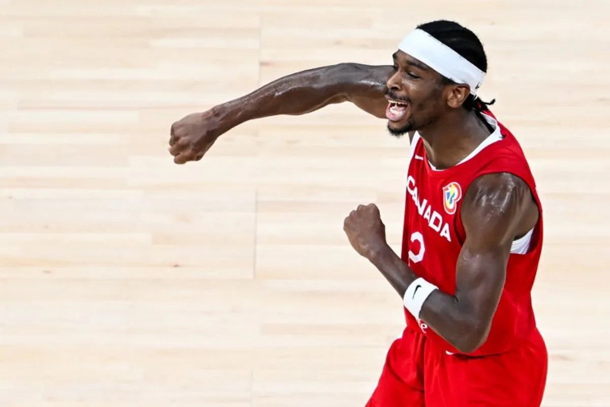 Canada's Shai Gilgeous-Alexander celebrates victory at the end of the FIBA Basketball World Cup game for third place between Canada and USA in Manila on September 10, 2023. SHERWIN VARDELEON / AFP
