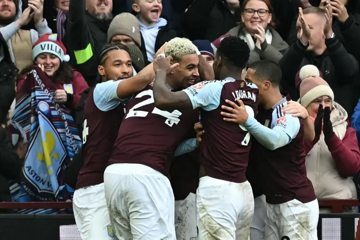 Aston Villa's English midfielder #27 Morgan Rogers (C) celebrates with teammates after scoring their second goal during the English Premier League football match between Aston Villa and Manchester City at Villa Park in Birmingham, central England on December 21, 2024.  Paul ELLIS / AFP