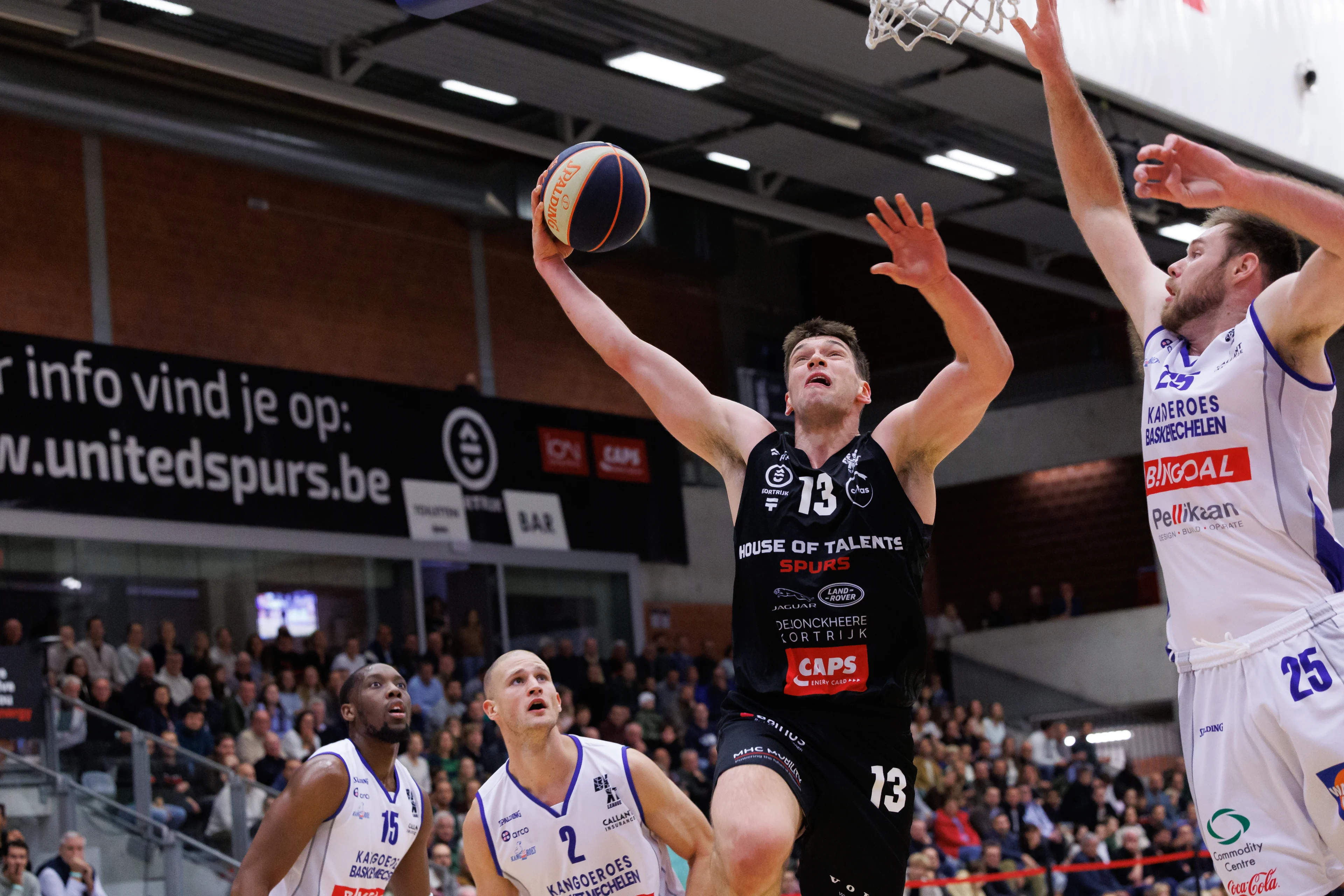 Kortrijk's Niels De Ridder and Mechelen's Brayden Parker fight for the ball during a basketball match between House of Talents Spurs Kortrijk and Kangoeroes Mechelen, Friday 11 October 2024, in Kortrijk, on day 5 of the 'BNXT League' first division basket championship. BELGA PHOTO KURT DESPLENTER