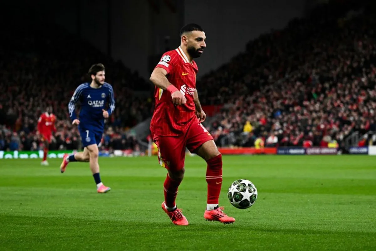 Liverpool's Egyptian striker #11 Mohamed Salah controls the ball during the last 16 second leg UEFA Champions League football match between Liverpool and Paris Saint-Germain (PSG) at Anfield in Liverpool, north west England on March 11, 2025.  Oli SCARFF / AFP