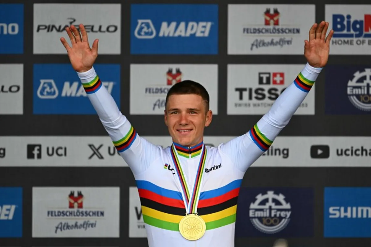 Gold medallist Belgium's Remco Evenepoel poses on the podium of the men's Elite Individual Time Trial cycling event, 46,1km from and to Zurich, during the UCI 2024 Road World Championships, in Zurich, on September 22, 2024.  Fabrice COFFRINI / AFP