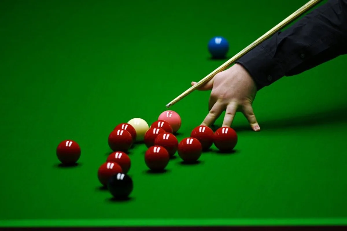 Jackson Page of Wales plays a shot during the World Snooker Championship Round Two match against Mark Williams of Wales at the Crucible Theatre, in Sheffield, northern England, on April 22, 2022.   OLI SCARFF / AFP