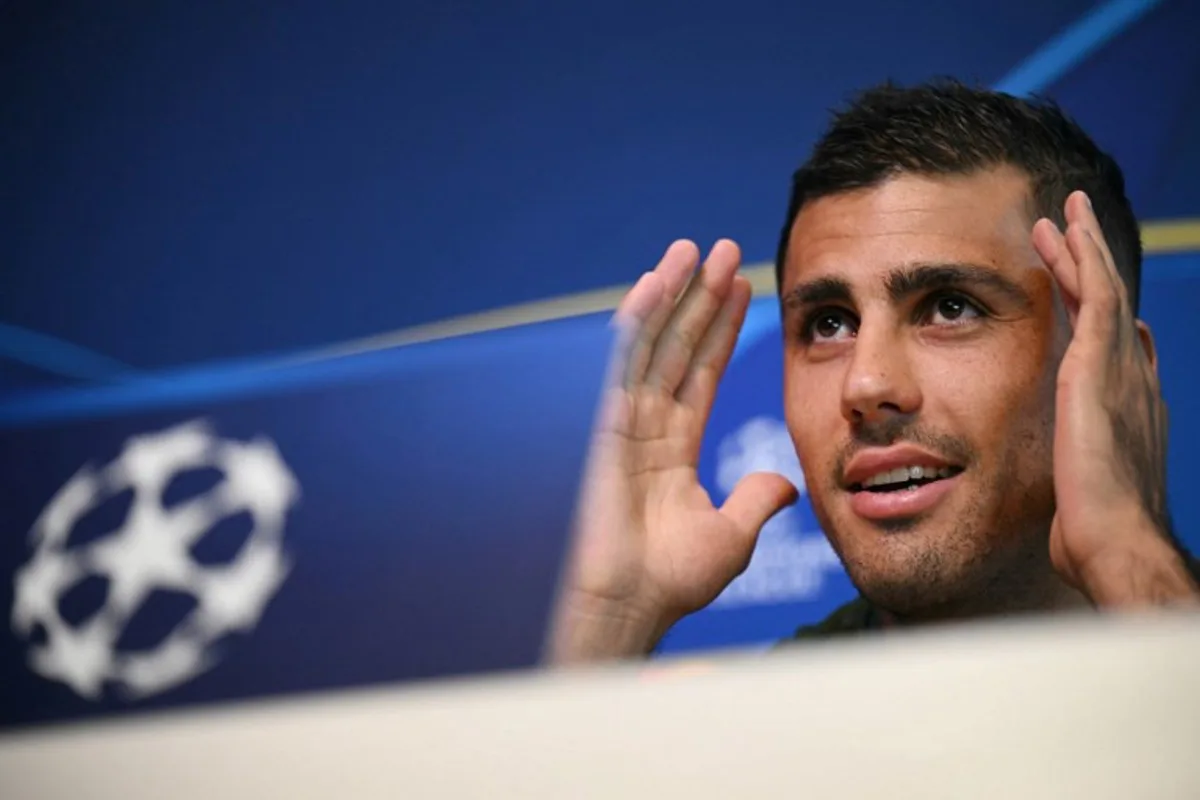 Manchester City's Spanish midfielder #16 Rodri gestures as he speaks during a press conference at the Manchester City's training ground, in Manchester, north-west England, on September 17, 2024, on the eve of their UEFA Champions League football match against Inter Milan.   Oli SCARFF / AFP