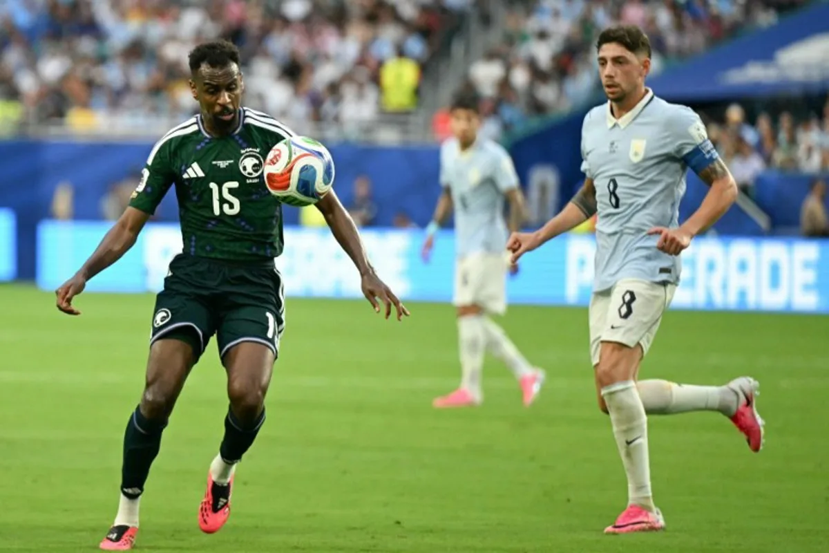 Saudi Arabia's midfielder #15 Abdullah Al-Khaibari and Uruguay's midfielder #08 Federico Valverde fight for the ball during the 2026 World Cup Group H football match between Saudi Arabia and Uruguay at the Miami Stadium in Miami Gardens on June 15, 2026. CHANDAN KHANNA / AFP