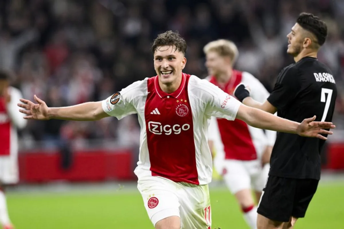 Ajax's Belgian forward #11 Mika Godts celebrates scoring his team's fourth goal during the UEFA Europa League football match between Ajax Amsterdam and Besiktas at The Johan Cruijff Arena Stadium in Amsterdam on September 26, 2024.  JOHN THYS / AFP