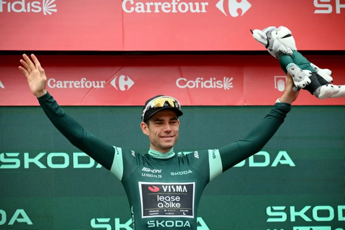 Team Visma-Lease a bike's Belgian rider Wout van Aert celebrates on the podium wearing the points ranking leader's green jersey after the 11th stage of the Vuelta a Espana 2026 cycling tour, a 151,3 km race between Carthagena and Lorca, on September 2, 2026. JOSE JORDAN / AFP