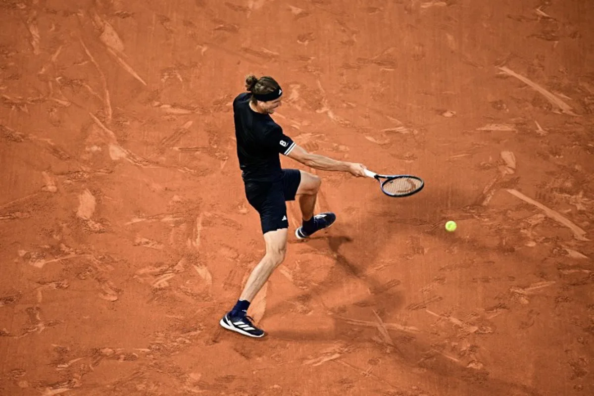 Germany's Alexander Zverev plays a forehand return to Czech Republic's Tomas Machac during their men's singles match on day 4 of the French Open tennis tournament on Court Philippe-Chatrier at the Roland-Garros Complex in Paris on May 27, 2026. JULIEN DE ROSA / AFP