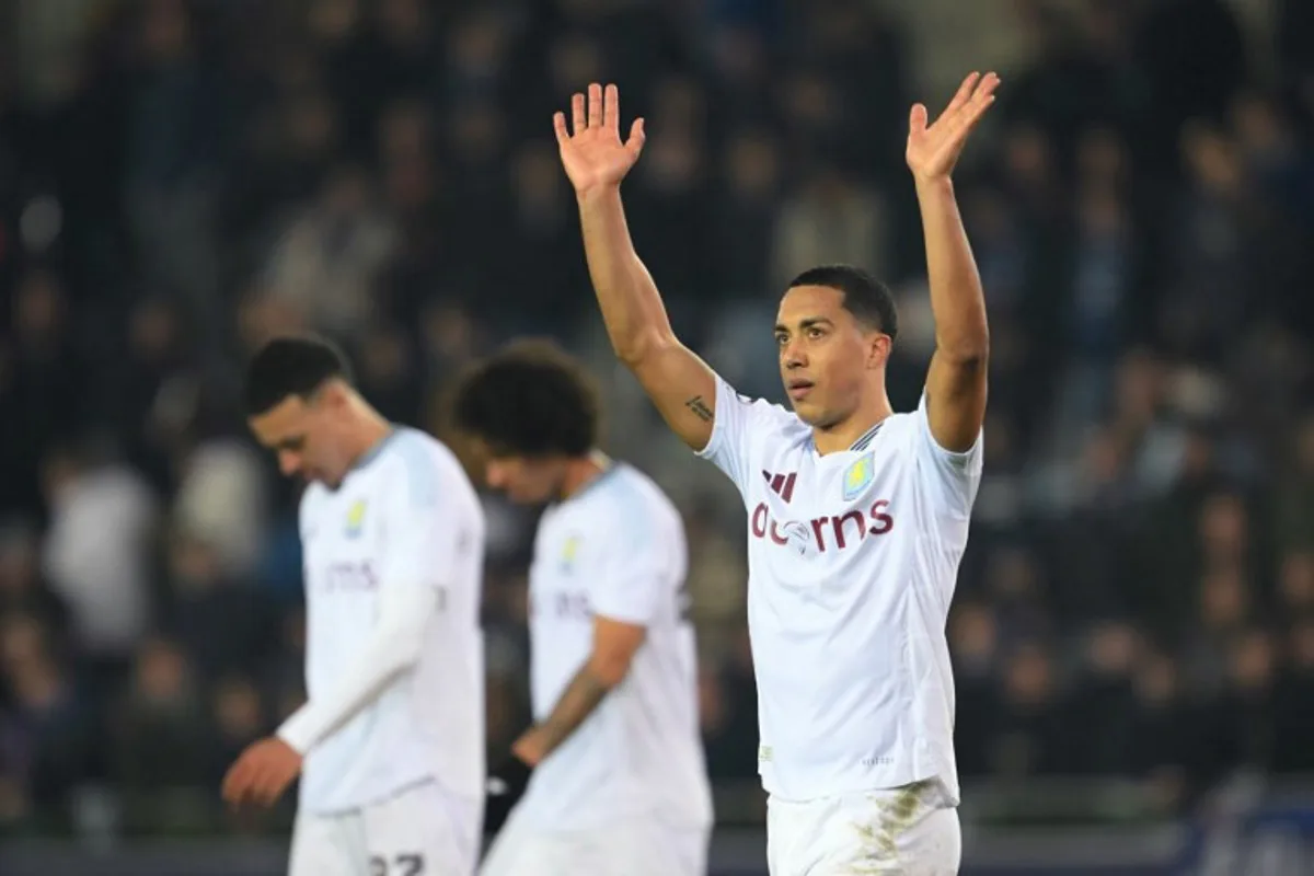 Aston Villa's Belgian midfielder #08 Youri Tielemans (R) celebrates after winning the UEFA Champions League round of 16 first leg football match between Club Brugge KV and Aston Villa FC at the Jan Breydel Stadium in Bruges, on March 4, 2025.  NICOLAS TUCAT / AFP