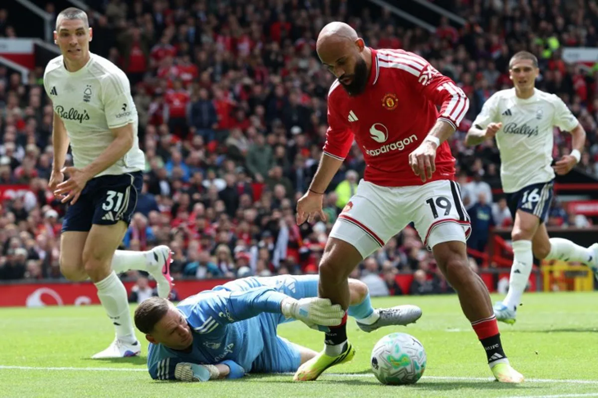 Manchester United's Cameroonian midfielder #19 Bryan Mbeumo (R) takes the ball around Nottingham Forest's Belgian goalkeeper #26 Matz Sels during the English Premier League football match between Manchester United and Nottingham Forest at Old Trafford in Manchester, north west England, on May 17, 2026.  Darren Staples / AFP