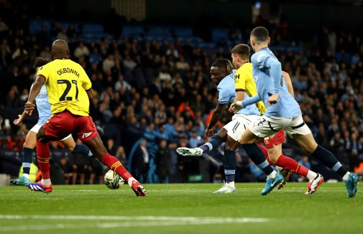 Manchester City's Belgian midfielder #11 Jeremy Doku scores the team's first goal during the English League Cup third round football match between Manchester City and Watford at the Etihad stadium in Manchester, northwest England on September 24, 2024.  Darren Staples / AFP