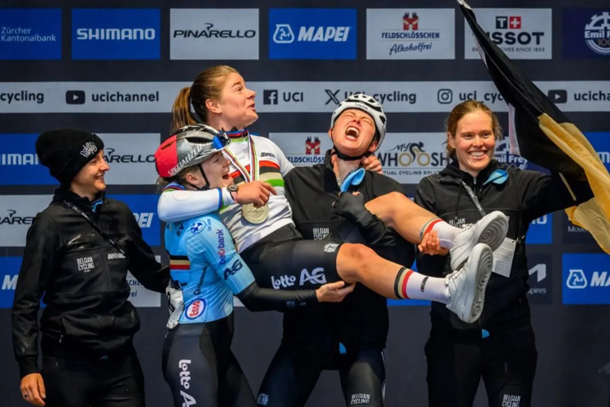 Belgian team celebrates with winner Belgium's Lotte Kopecky (C) during the podium ceremony of the women's Elite Road Race cycling event as part of the UCI 2024 Road World Championships, in Zurich, on September 28, 2024.  Fabrice COFFRINI / AFP