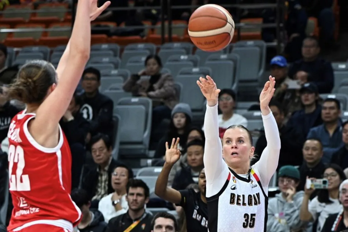 Belgium´s Julie Vanloo (R) shoots under the pressure of Czech Republic´s Emma Cechova during the FIBA Women's Basketball World Cup 2026 qualifying tournament game between Belgium and Czech Republic in Wuhan, in China's central Hubei province on March 17, 2026. CN-STR / AFP