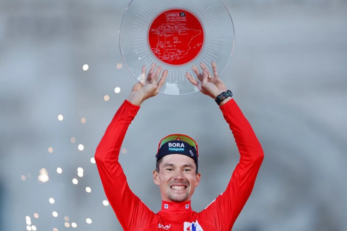 Overall leader Team Bora's Primoz Roglic celebrates on the podium after the last stage of the Vuelta a Espana, a 24,6 km time-trial race between Madrid and Madrid, on September 8, 2024.    OSCAR DEL POZO / AFP