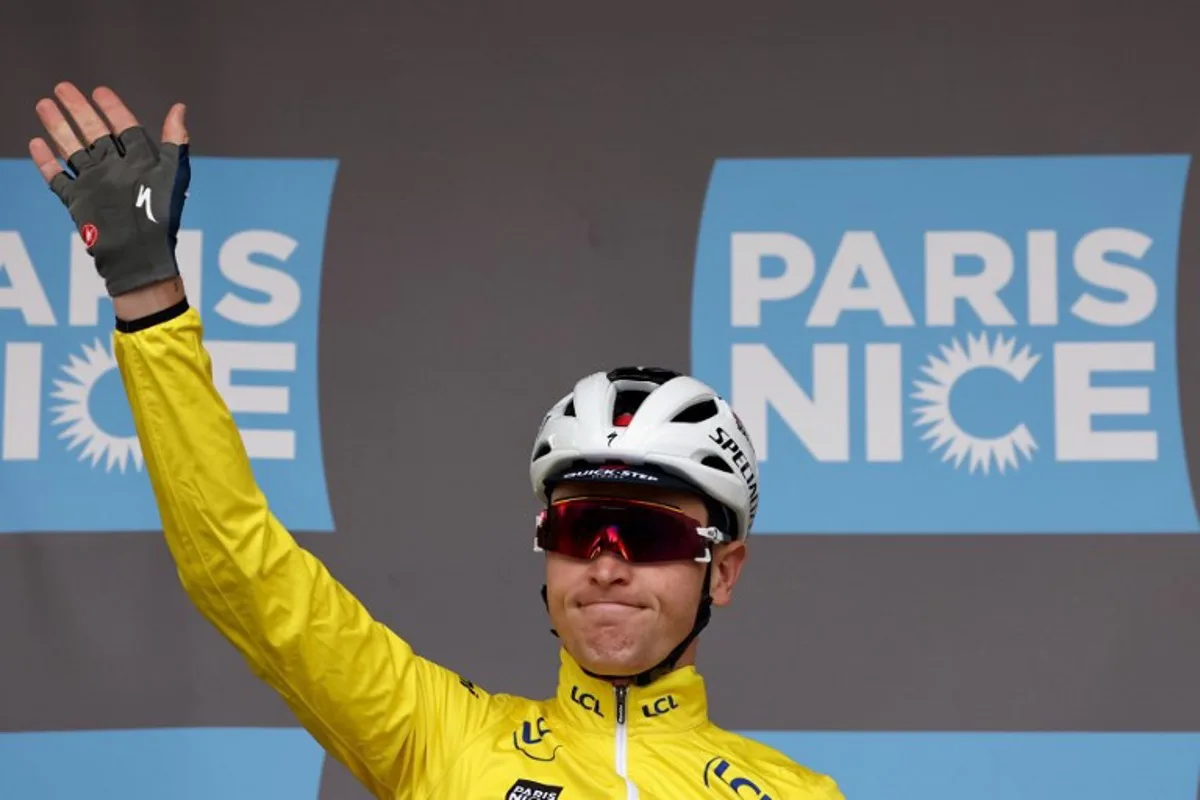 Soudal Quick-Step's Belgian rider Tim Merlier wearing the overall leader's yellow jersey reacts prior to the 2nd stage of the Paris-Nice cycling race, 183,9 km between Montesson and Bellegarde, on March 10, 2025.  Anne-Christine POUJOULAT / AFP