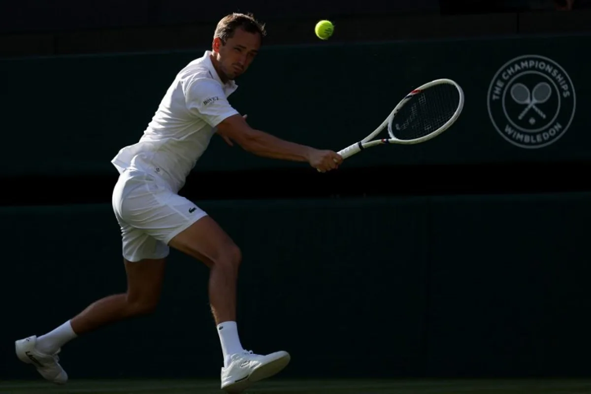 Russia's Daniil Medvedev returns to Croatia's Marin Cilic during their men's singles first round tennis match on the first day of the 2026 Wimbledon Championships at The All England Lawn Tennis and Croquet Club in Wimbledon, southwest London, on June 29, 2026.  Adrian Dennis / AFP