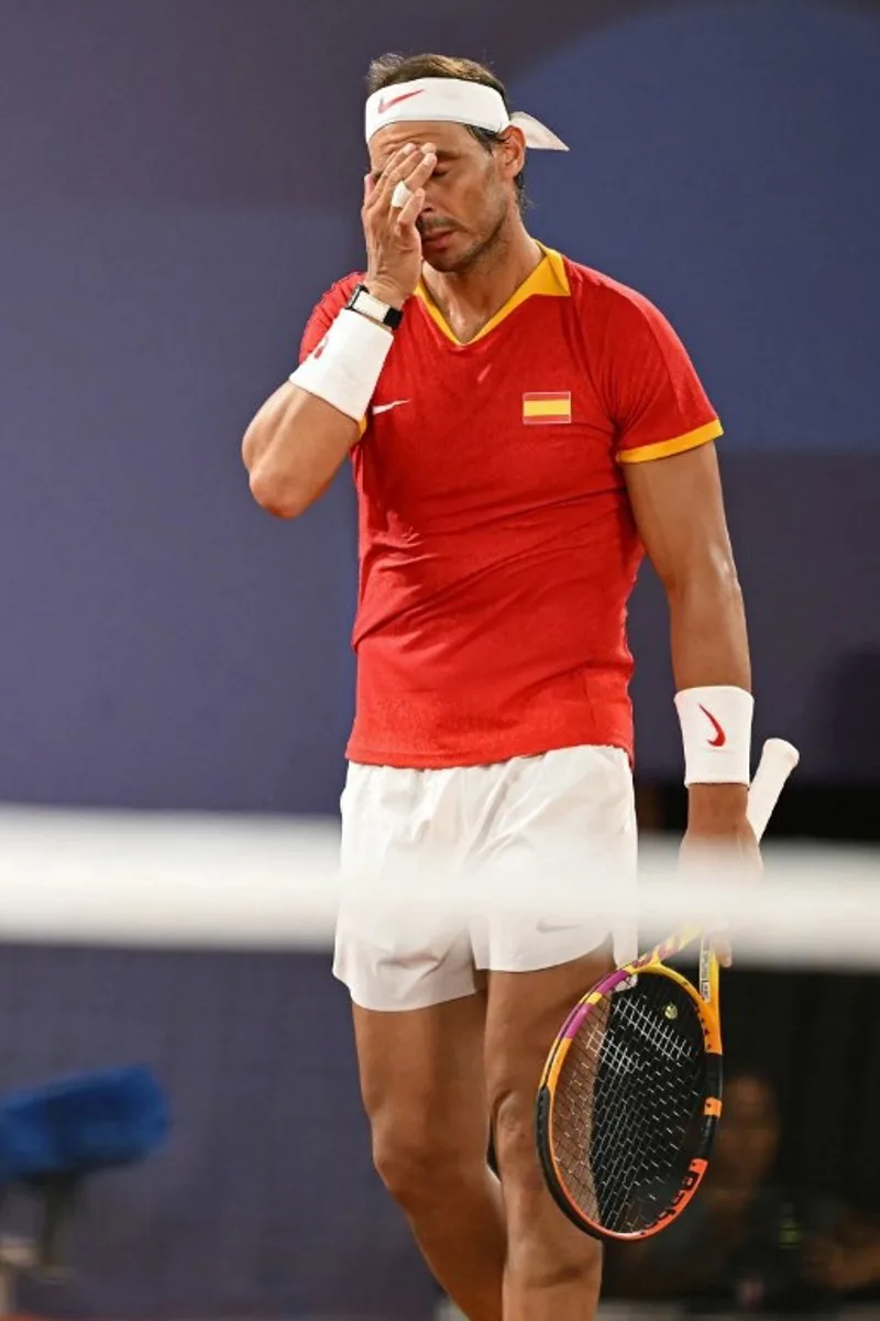 Spain's Rafael Nadal reacts playing with Spain's Carlos Alcaraz against US' Austin Krajicek and US' Rajeev Ram during their men's doubles quarter-final tennis match on Court Philippe-Chatrier at the Roland-Garros Stadium during the Paris 2024 Olympic Games, in Paris on July 31, 2024.   CARL DE SOUZA / AFP