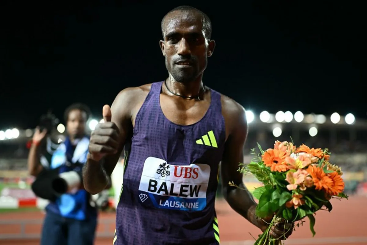 Bahrain's Birhanu Balew celebrates after winning the men's 5000m during the World Athletics Diamond League athletics meeting at the Stade Olympique de la Pontaise in Lausanne, on August 21, 2026. Fabrice COFFRINI / AFP