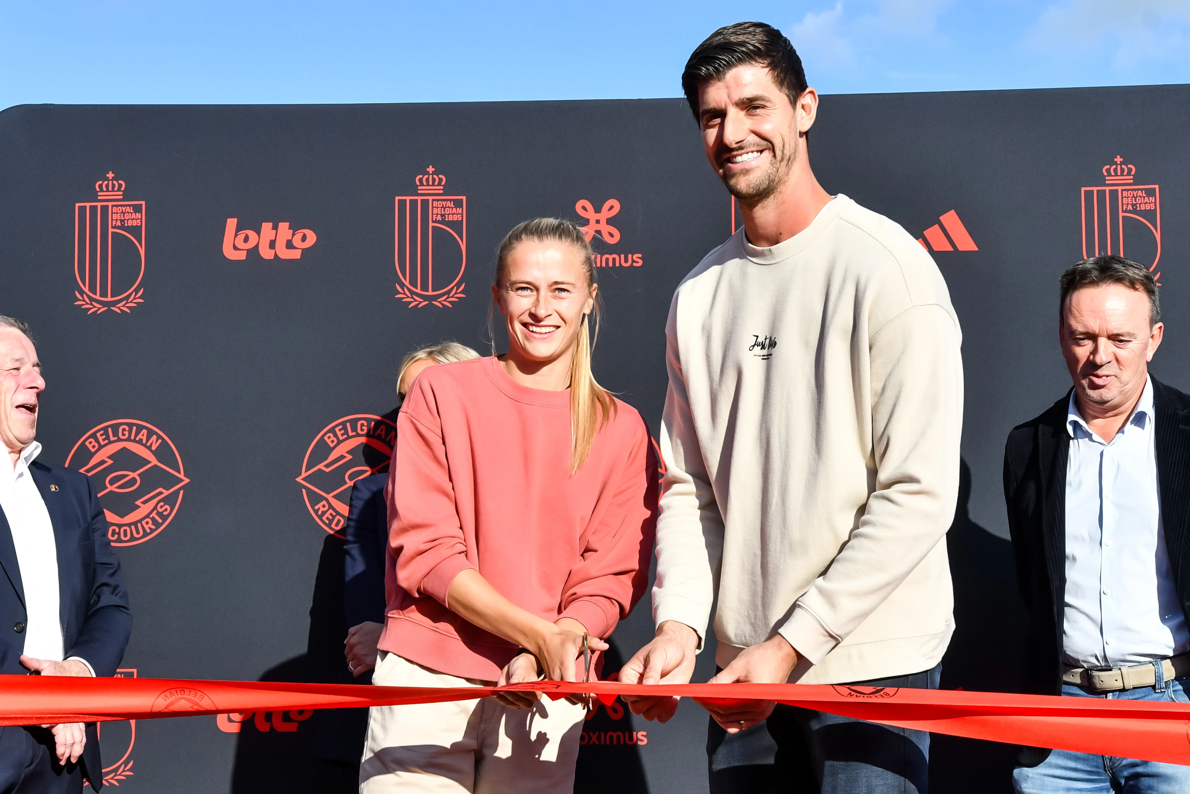 Belgium's Julie Biesmans and Belgium's goalkeeper Thibaut Courtois pictured during the inauguration of the tenth Belgian Red Court, a new social football pitch in Bilzen, Friday 11 October 2024. BELGA PHOTO JILL DELSAUX