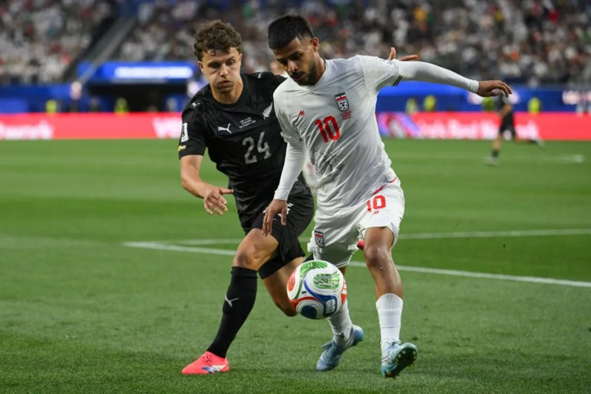 New Zealand's defender #24 Callan Elliot and Iran's midfielder #10 Mehdi Ghayedi fight for the ball during the 2026 World Cup Group G football match between Iran and New Zealand at Los Angeles Stadium in Inglewood on June 15, 2026.   Patrick T. Fallon / AFP
