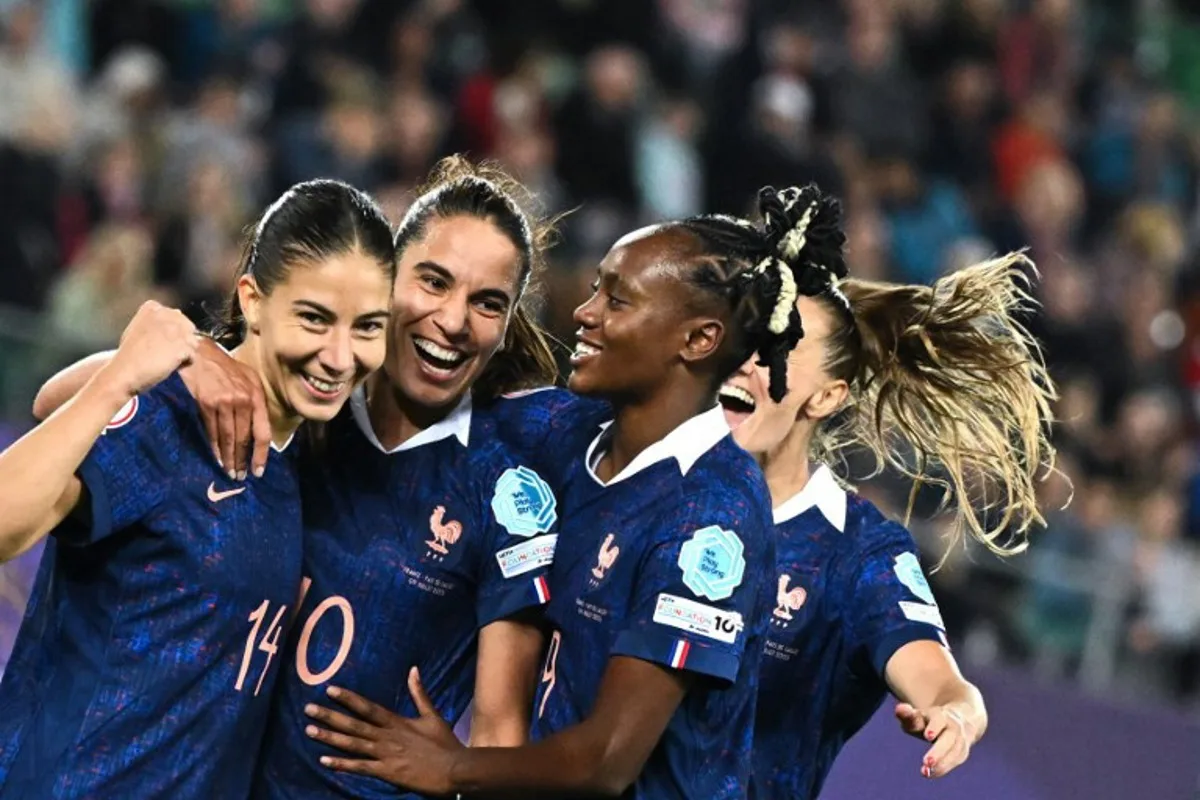 France's midfielder #10 Amel Majri (2ndL) celebrates after scoring the third goal of the match with France's forward #14 Clara Mateo and France's forward #09 Melvine Malard during the UEFA Women's Euro 2025 Group D football match between France and Wales at the Arena St.Gallen in St. Gallen on July 9, 2025. SEBASTIEN BOZON / AFP