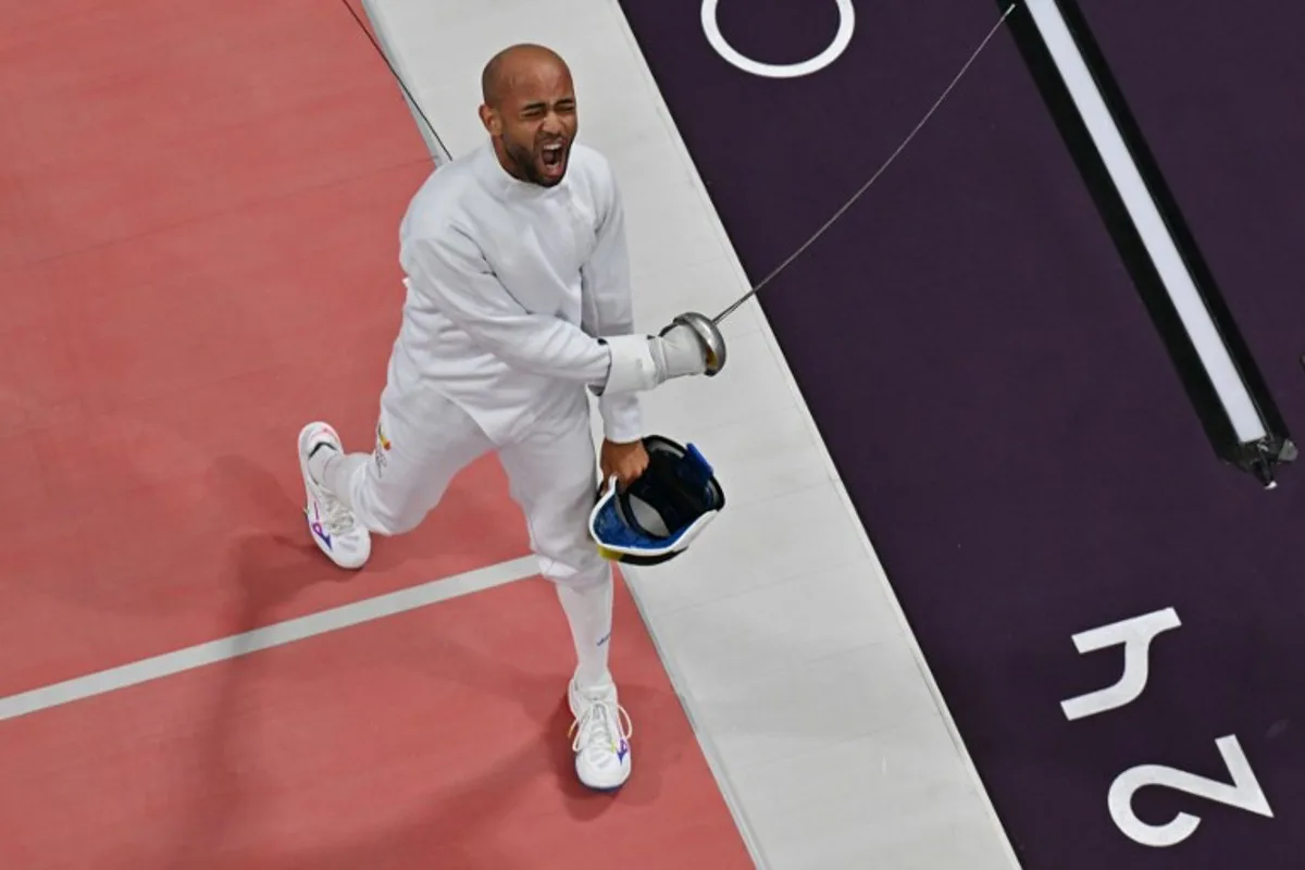 An overview shows Belgium's Neisser Loyola (L) reacting as he competes against Hungary's Gergely Siklosi in the men's epee individual round of 16 bout during the Paris 2024 Olympic Games at the Grand Palais in Paris, on July 28, 2024. Jewel SAMAD / AFP