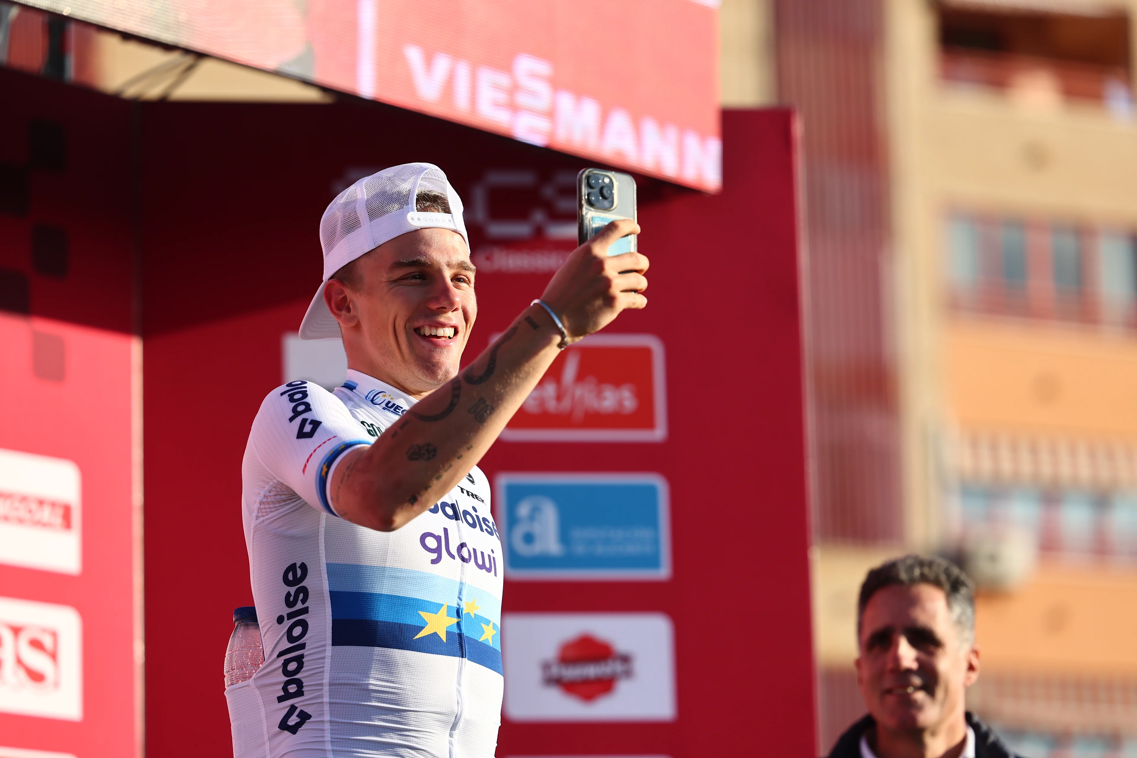 Winner Belgian Thibau Nys using his smartphone on the podium after winning the men's elite race at the cyclocross cycling event in Benidorm, Spain, Sunday 19 January 2025, stage 12/14 in the UCI World Cup competition. BELGA PHOTO DAVID PINTENS