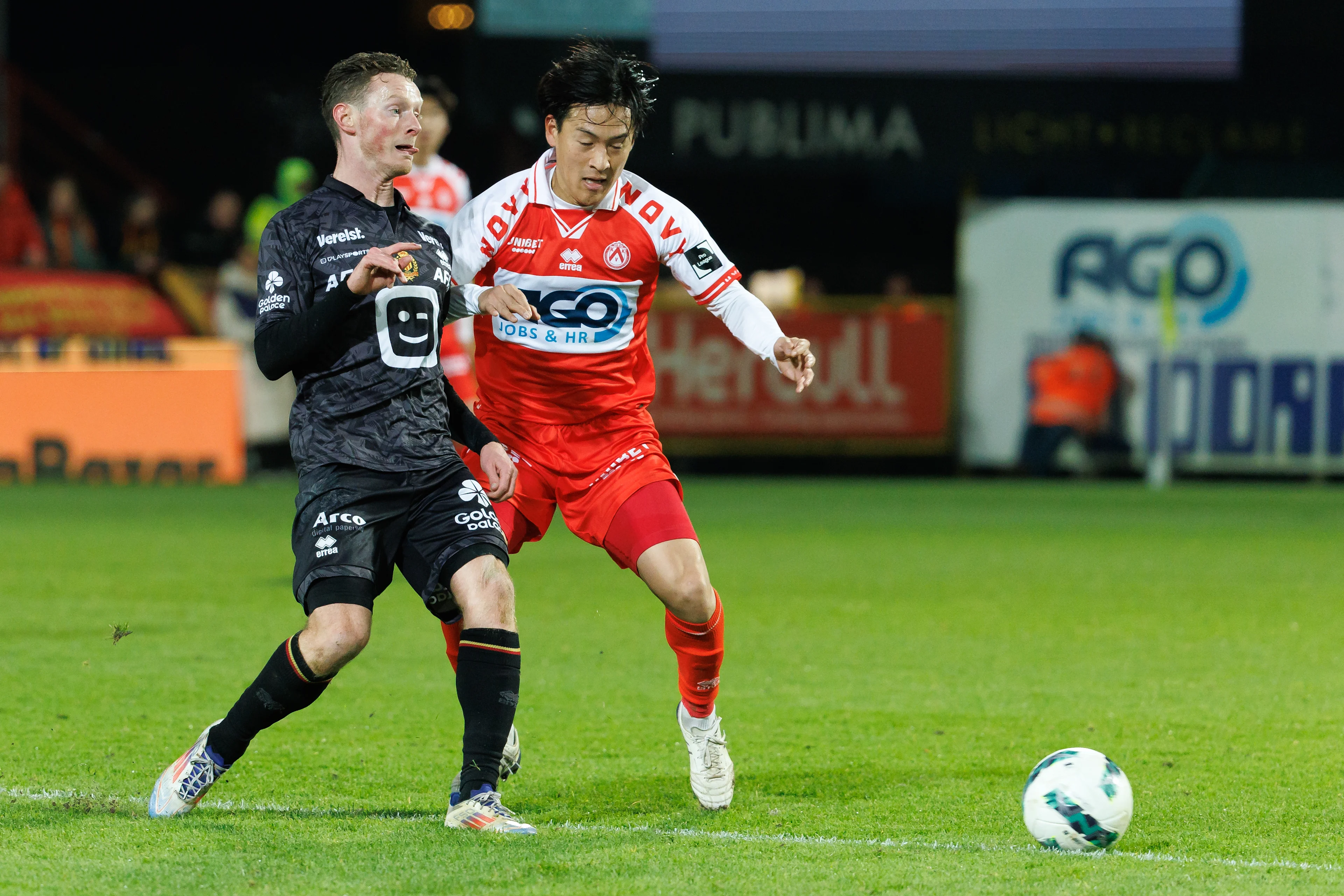 Mechelen's Rob Schoofs and Kortrijk's Tomoki Takamine fight for the ball during a soccer match between KV Kortrijk and KV Mechelen, Friday 29 November 2024 in Kortrijk, on day 16 of the 2024-2025 season of the 'Jupiler Pro League' first division of the Belgian championship. BELGA PHOTO KURT DESPLENTER