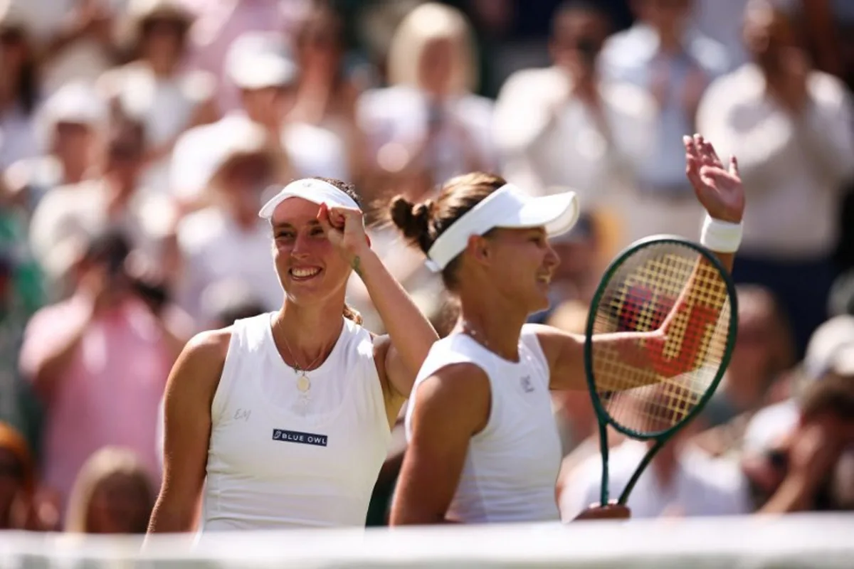 Russia's Veronika Kudermetova (R) and Belgium's Elise Mertens celebrate following their victory at the end of their women's doubles final tennis match against Taiwan's Hsieh Su-wei playing with Latvia's Jelena Ostapenko on the fourteenth day of the 2025 Wimbledon Championships at The All England Lawn Tennis and Croquet Club in Wimbledon, southwest London, on July 13, 2025. HENRY NICHOLLS / AFP