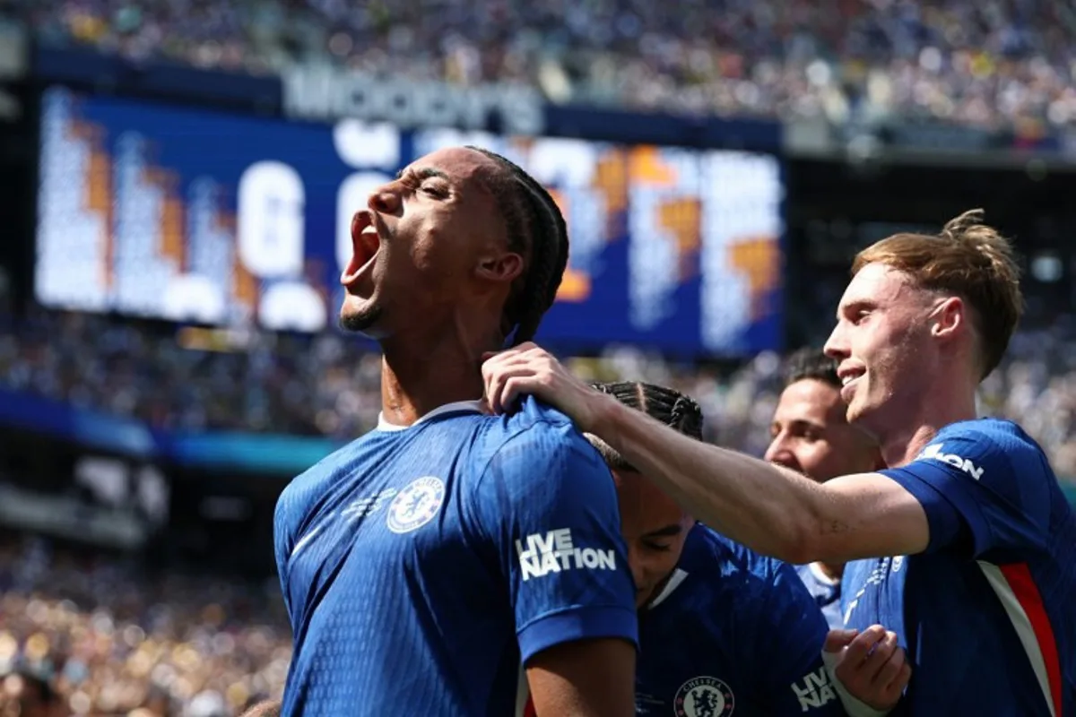 Chelsea's Brazilian forward #20 Joao Pedro (L) celebrates scoring his team's third goal with Chelsea's English midfielder #10 Cole Palmer during the FIFA Club World Cup 2025 final football match between England's Chelsea and France's Paris Saint-Germain at the MetLife Stadium in East Rutherford, New Jersey on July 13, 2025. FRANCK FIFE / AFP