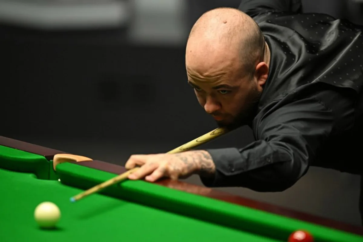 Belgium's Luca Brecel plays a shot against England's Mark Selby during the afternoon session on day two of their World Championship Snooker final match at The Crucible in Sheffield, northern England on May 1, 2023.   Oli SCARFF / AFP