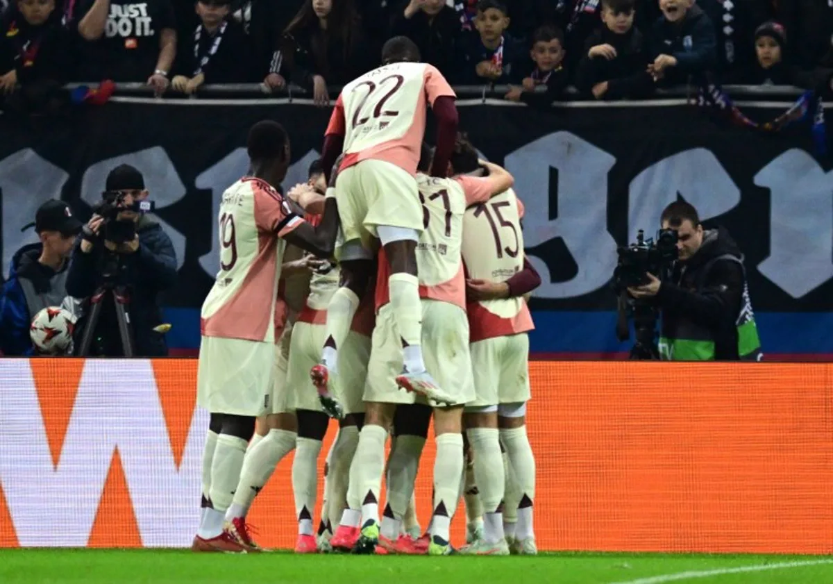 Lyon's Argentine defender #03 Nicolas Tagliafico (hidden) is celebrated by team mates after scoring the 0-1 opening goal during the UEFA Europa League last 16, 1st leg football match between FC Steaua Bucharest v Olympique Lyonnais (OL) in Bucharest, Romania, on March 6, 2025.  Daniel MIHAILESCU / AFP