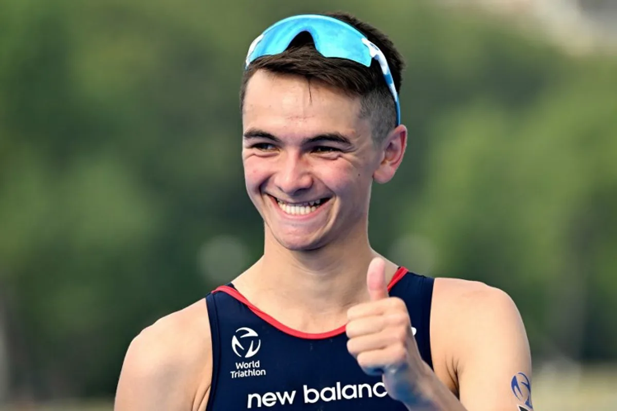 Great Britain's triathlon athlete Alex Yee gives a thumbs up after winning the men's 2023 World Triathlon Olympic Games Test Event in Paris, on August 18, 2023. From August 17 to 20, 2023, Paris 2024 is organising four triathlon events to test several arrangements, such as the sports operations, one year before the Paris 2024 Olympic and Paralympic Games. The swim familiarisation event follows the cancellation on August 6 of the pre-Olympics test swimming competition due to excessive pollution which forced organisers to cancel the pre-Olympics event. Bertrand GUAY / AFP