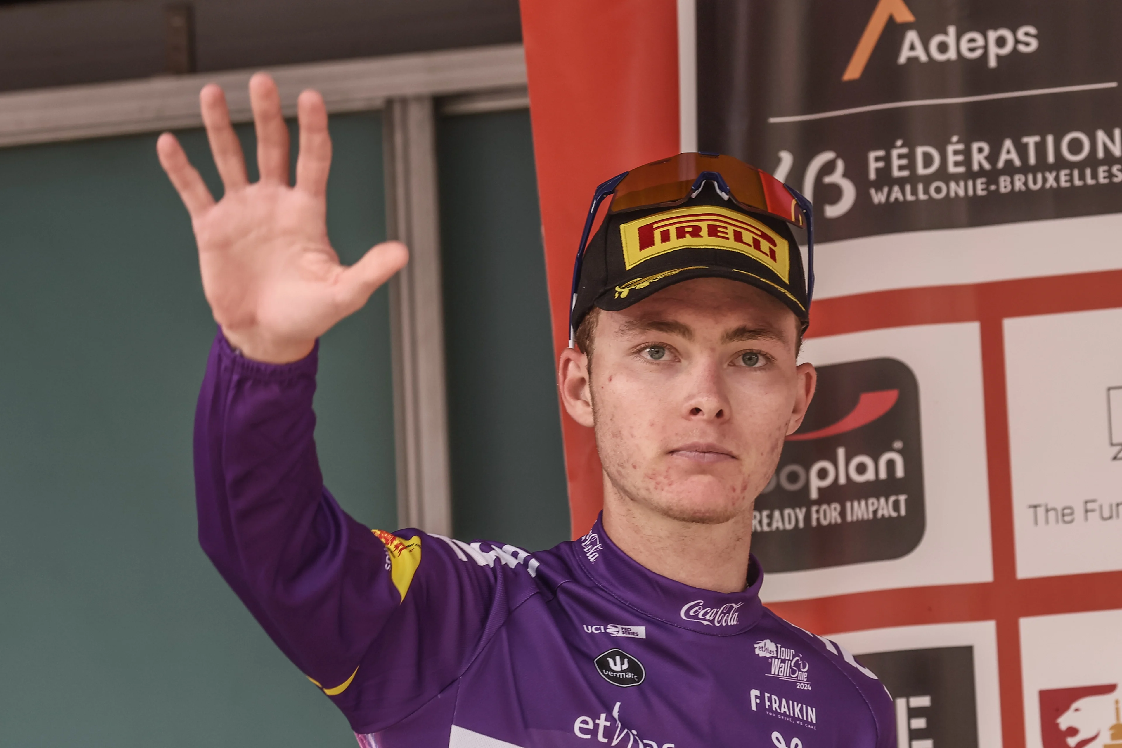 Cole Kessler celebrates on the podium wearing the purple jersey of leader in the sprint ranking after the stage 4 of the Tour De Wallonie cycling race, from Verviers to Herve (187 km), Thursday 25 July 2024. This year's Tour de Wallonie takes place from 22 to 26 July 2023. BELGA PHOTO BRUNO FAHY